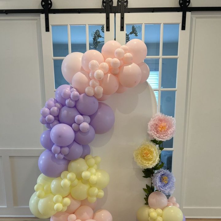 Chiara arched panel backdrop with a pastel balloon garland and florals in Wake Forest, NC