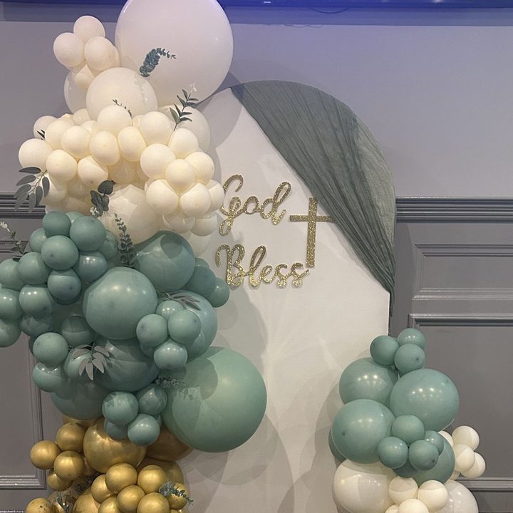Chiara arched panel backdrop with a sage, ivory and gold balloon garland in Raleigh, NC