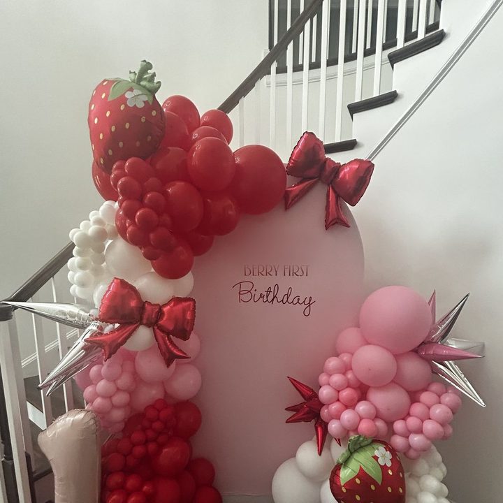 Chiara arched panel backdrop with a red and pink strawberry balloon garland in Raleigh, NC
