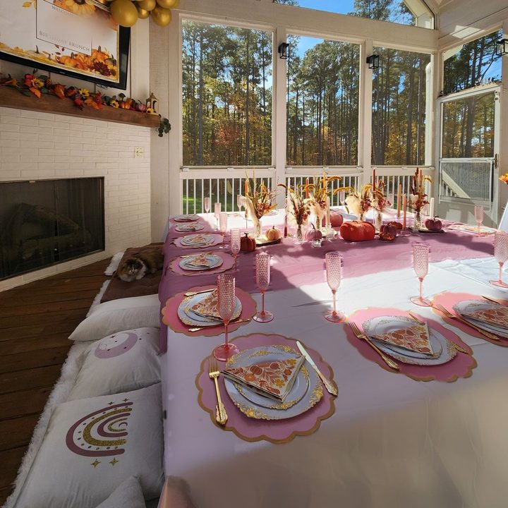 Fall porch table with a pressed white linen, mauve runner and gold place settings in Wake Forest, NC