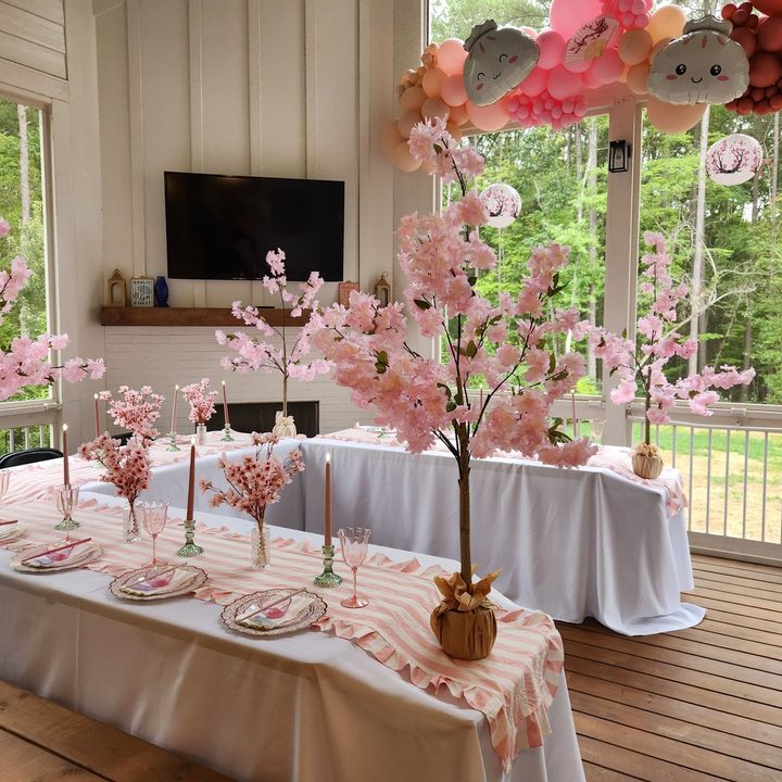 Styled tablescape with white linens and cherry blossom centerpieces in Wake Forest, NC
