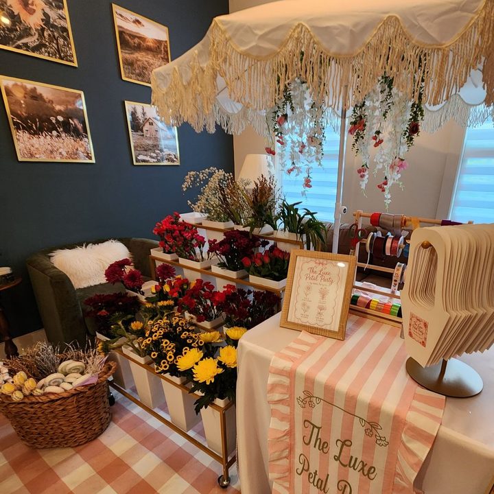 The Luxe Petal Party bloom bar with fresh flowers and a fringed canopy in Wake Forest, NC