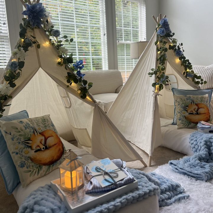 Styled sleepover tents with string lights and bedding in Raleigh, NC
