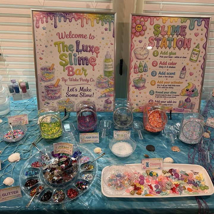 The Luxe Slime Bar station with jars of colorful add-ins and signage